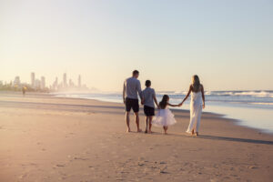 Family walking beach Gold Coast